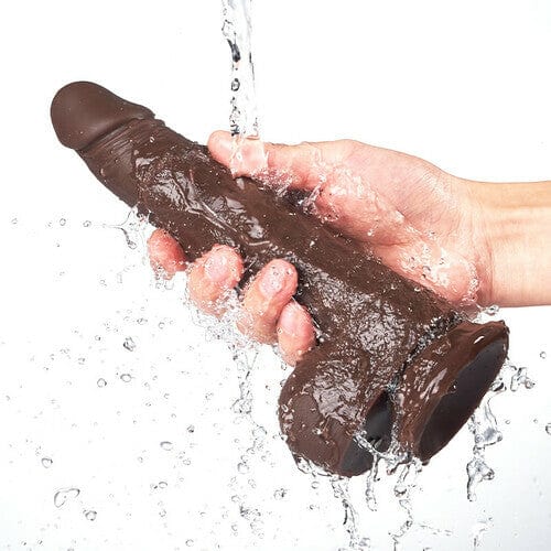 Aroselove K05 black coffee vibrating rod being held under water, side view